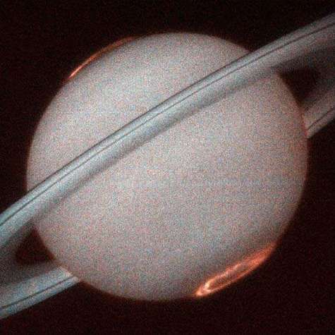 Saturn, photographed from terrestrial orbit by the Hubble space telescope showing the polar auroras.