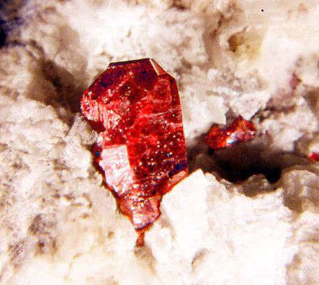 Cinnabar crystal. An isolated red, rhombohedral crystal of cinnabar on Fenghuang dolomite, Hunan Province, China. © webmineral